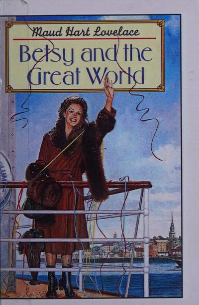 A cream field with a thin red-and-gold double-rule border; the author's name 'Maud Hart Lovelace' in blue cursive script above the title 'Betsy and the Great World' in blue serif capitals, both set on a parchment-colored nameplate; below it a painted illustration of a young woman in a fur-trimmed coat waving from the railing of an ocean liner, streamers trailing from her hand, a harbor town visible behind her.