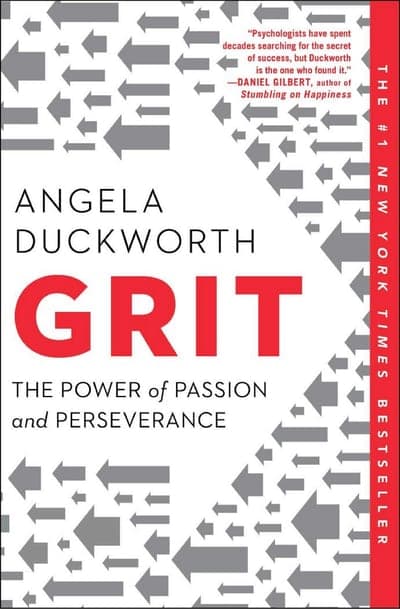 A white jacket scattered with grey directional arrows pointing every way, a bold red vertical band down the right edge reading '#1 NEW YORK TIMES BESTSELLER,' the author's name ANGELA DUCKWORTH in black serif capitals above the title, GRIT in huge red bold capitals, and the subtitle 'The Power of Passion and Perseverance' beneath it in black serif.