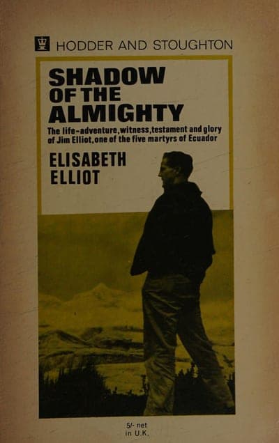 A Hodder and Stoughton paperback of Shadow of the Almighty — a cream field with the Hodder crest and 'HODDER AND STOUGHTON' across the top, the title in bold black capitals inside a gold-ruled box with the line 'The life-adventure, witness, testament and glory of Jim Elliot, one of the five martyrs of Ecuador', 'ELISABETH ELLIOT' below it, and a sepia-toned photograph of a man standing on a mountain ridge filling the lower two-thirds; '5/- net in U.K.' is printed at the foot.