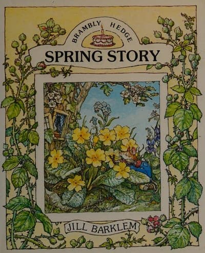 A Brambly Hedge jacket for Spring Story — a pale yellow field bordered by a hand-drawn wreath of pink and white blossoms and green leaves, a small birthday-cake device beside the series banner 'BRAMBLY HEDGE' at the top, the title 'SPRING STORY' in brown serif capitals beneath it, a square illustrated panel of a mouse among primroses beside a hollow-tree cottage in the center, and 'JILL BARKLEM' in a ribbon banner at the foot.