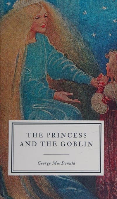 A dark blue starry-sky field with a painted illustration of a tall golden-haired woman in a pale blue gown reaching toward a smaller girl in a red dress with dark hair, a white rectangular title box lower on the cover reading 'THE PRINCESS AND THE GOBLIN' in black serif capitals with a thin double-rule border, and 'George MacDonald' in italic serif beneath it.