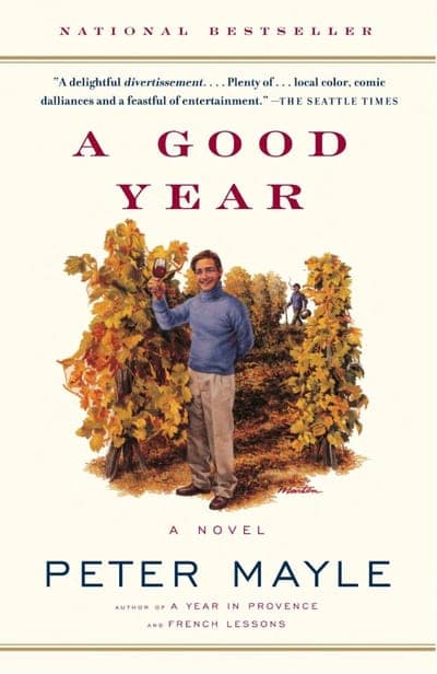A Vintage trade paperback edition of A Good Year by Peter Mayle — a cream cover with a painted illustration of a smiling man raising a wine glass amid golden autumn vineyard rows, "A GOOD YEAR" in maroon serif type above and "PETER MAYLE" in navy below.