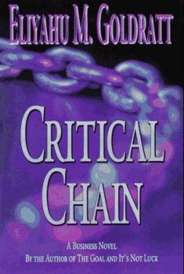 A business-novel edition of Critical Chain — a purple background with a glowing blue chain diagonally across the cover, the title in large white capitals below the author's name and a 'By the Author of The Goal and It's Not Luck' tagline.
