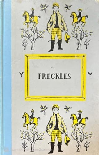 A pale grey-blue cloth hardcover photographed at a slight angle, decorated with repeating yellow-and-black line drawings of a boy in riding gear and jodhpurs flanked by two rearing horses, with 'FRECKLES' printed in a small yellow-bordered white panel at the center and a light blue cloth spine visible at the left edge.