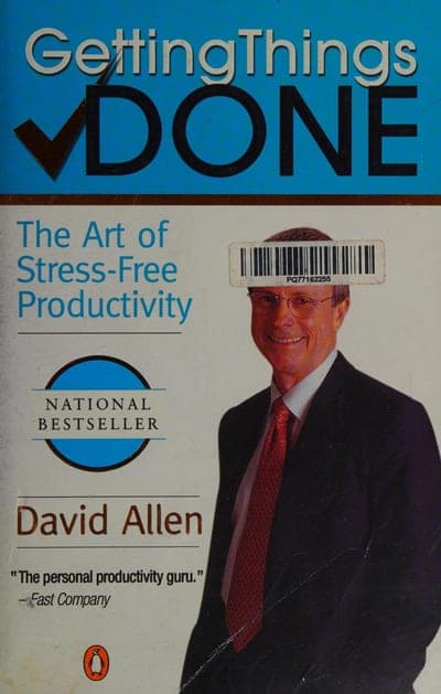 A light blue field with the title 'Getting Things DONE' set in a large slanted script for 'Getting Things' with a checkmark worked into the design and 'DONE' in bold black capitals beneath it, the line 'The Art of Stress-Free Productivity' in blue below that, a circular blue 'NATIONAL BESTSELLER' seal, a photo of the author in a suit and tie (partly covered by an old price-sticker barcode), the author's name 'David Allen' in brown serif, and a pull-quote reading 'The personal productivity guru.' — Fast Company near the bottom.