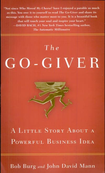 A brick-red field bordered top and bottom by thin gold rules, a blurbed quote from David Bach across the top, the title set as 'The' in small italic above GO-GIVER in huge white serif capitals, a small gold winged-messenger figure beneath it, the subtitle 'A Little Story About a Powerful Business Idea' in white serif below that, and the authors' names 'Bob Burg and John David Mann' in white at the bottom.