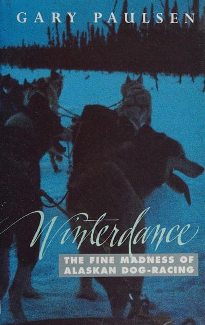 A night-blue jacket filled with a photo of a dog-sled team mid-run against a dark tree line, the author's name in white capitals across the top, the title 'Winterdance' set in pale cursive script over the image, and the subtitle in white capitals on a gray band beneath it.
